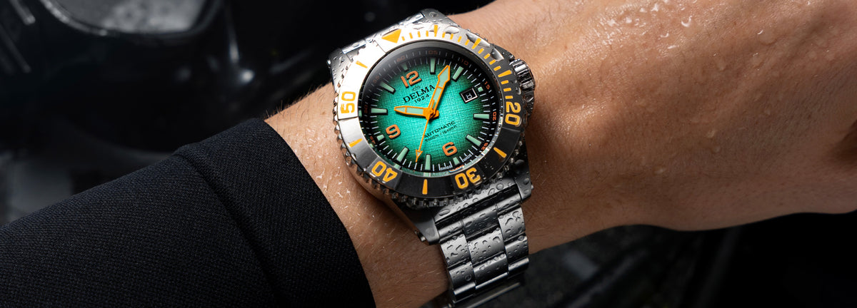 DELMA Blue Shark IV stainless steel watch with teal gradient dial on wrist