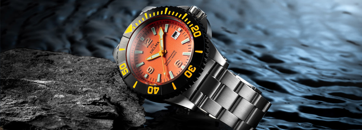 DELMA Blue Shark IV stainless steel watch with orange dial and black bezel in context