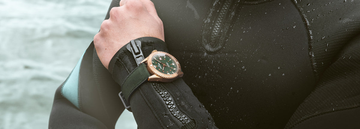 DELMA Cayman Bronze watch with green dial and green Cordura strap on diver