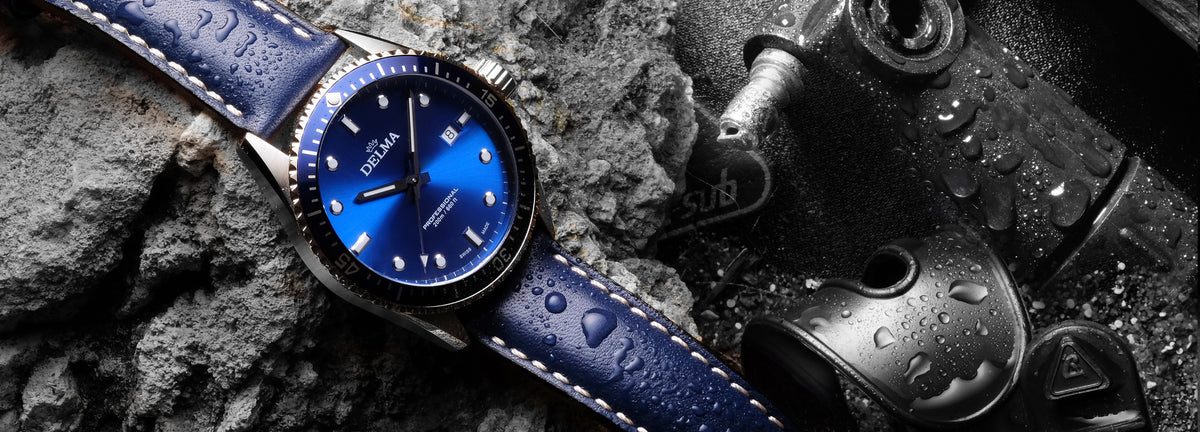 DELMA Cayman stainless steel watch with blue dial, bezel and leather strap