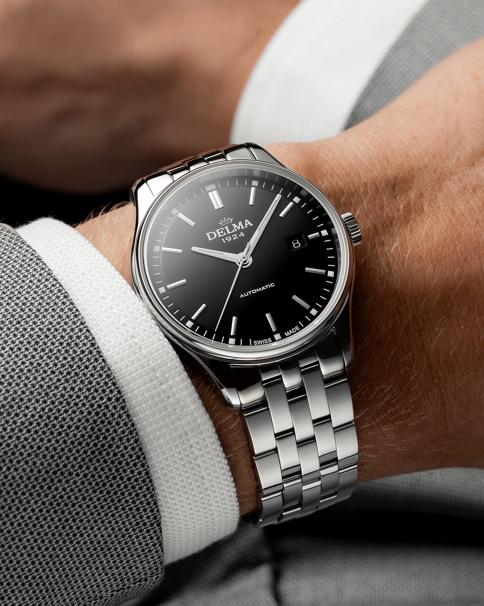 DELMA Classic stainless steel watch with black dial on wrist