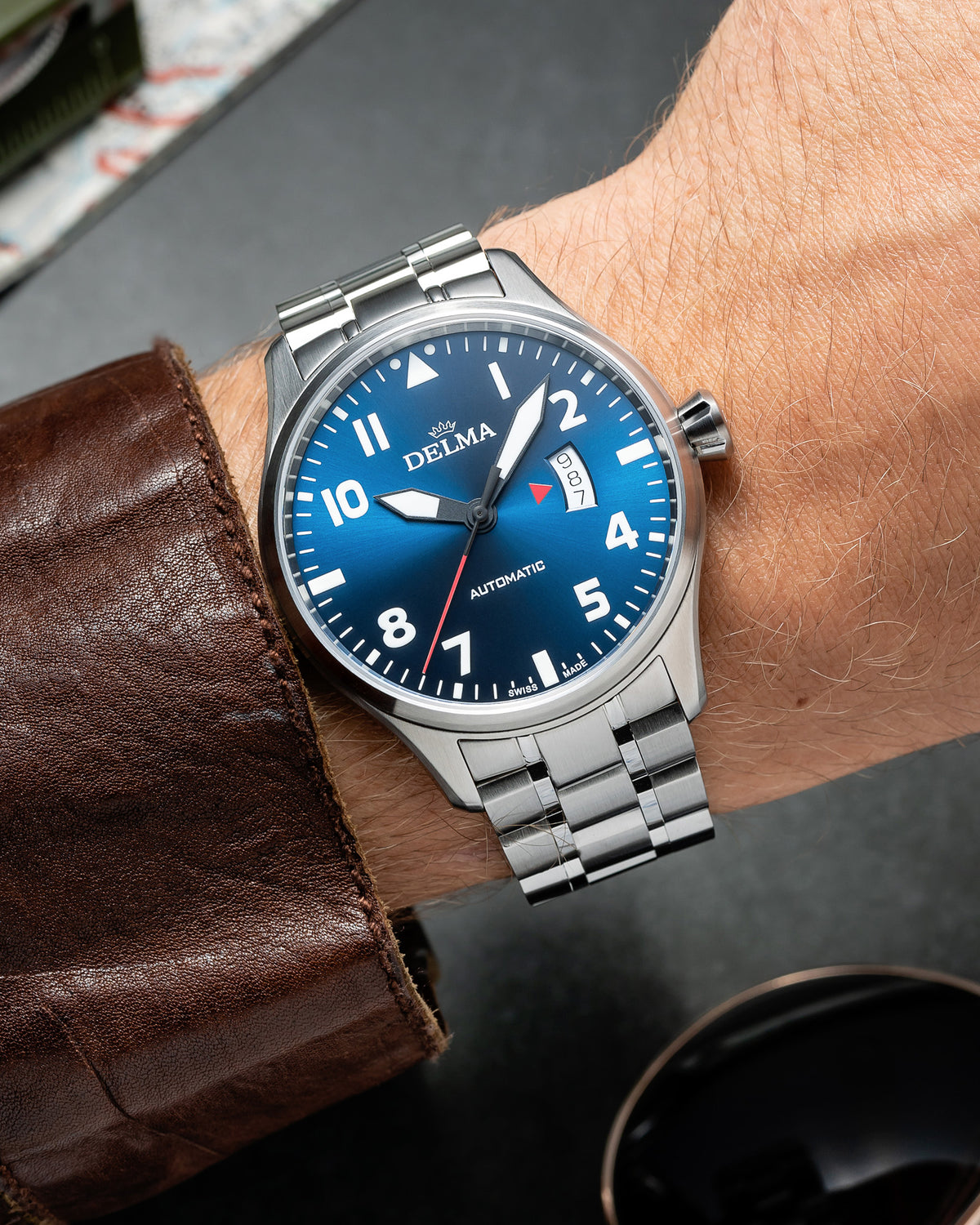 DELMA Commander stainless steel watch with blue dial on wrist