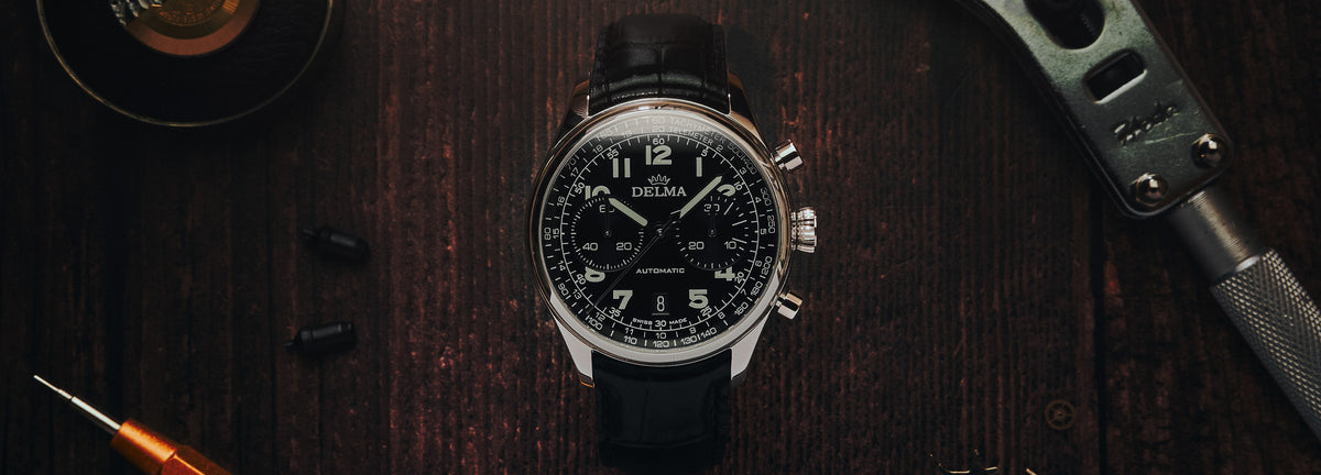 DELMA Heritage Chronograph LE stainless steel watch with black dial and black leather strap in context