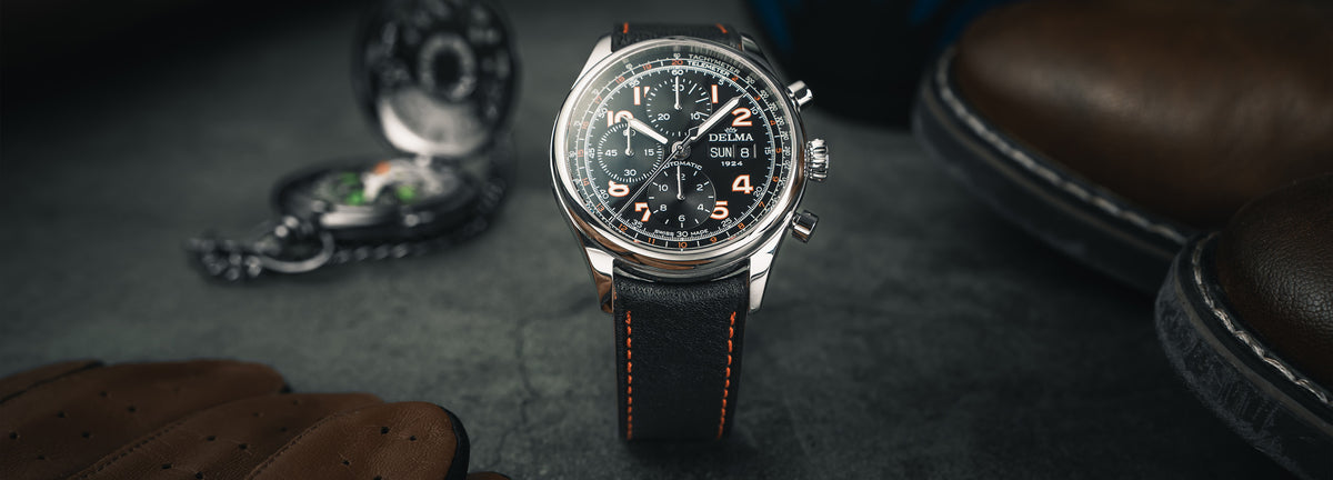DELMA Heritage Chronograph 100 Years LE stainless steel watch with black dial and black leather strap in context