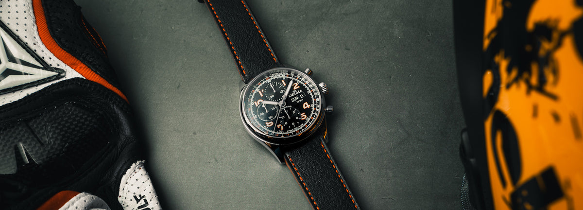 DELMA Heritage Chronograph 100 Years LE stainless steel watch with black dial and black leather strap in context