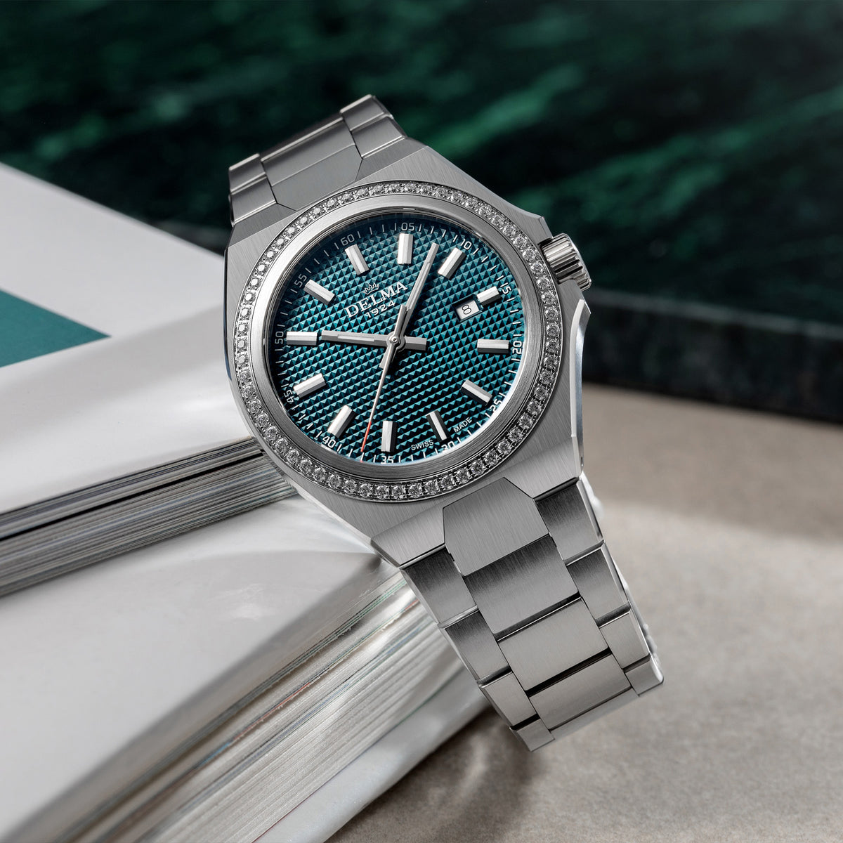DELMA Midland 34 mm stainless steel watch with teal dial and diamond bezel in context