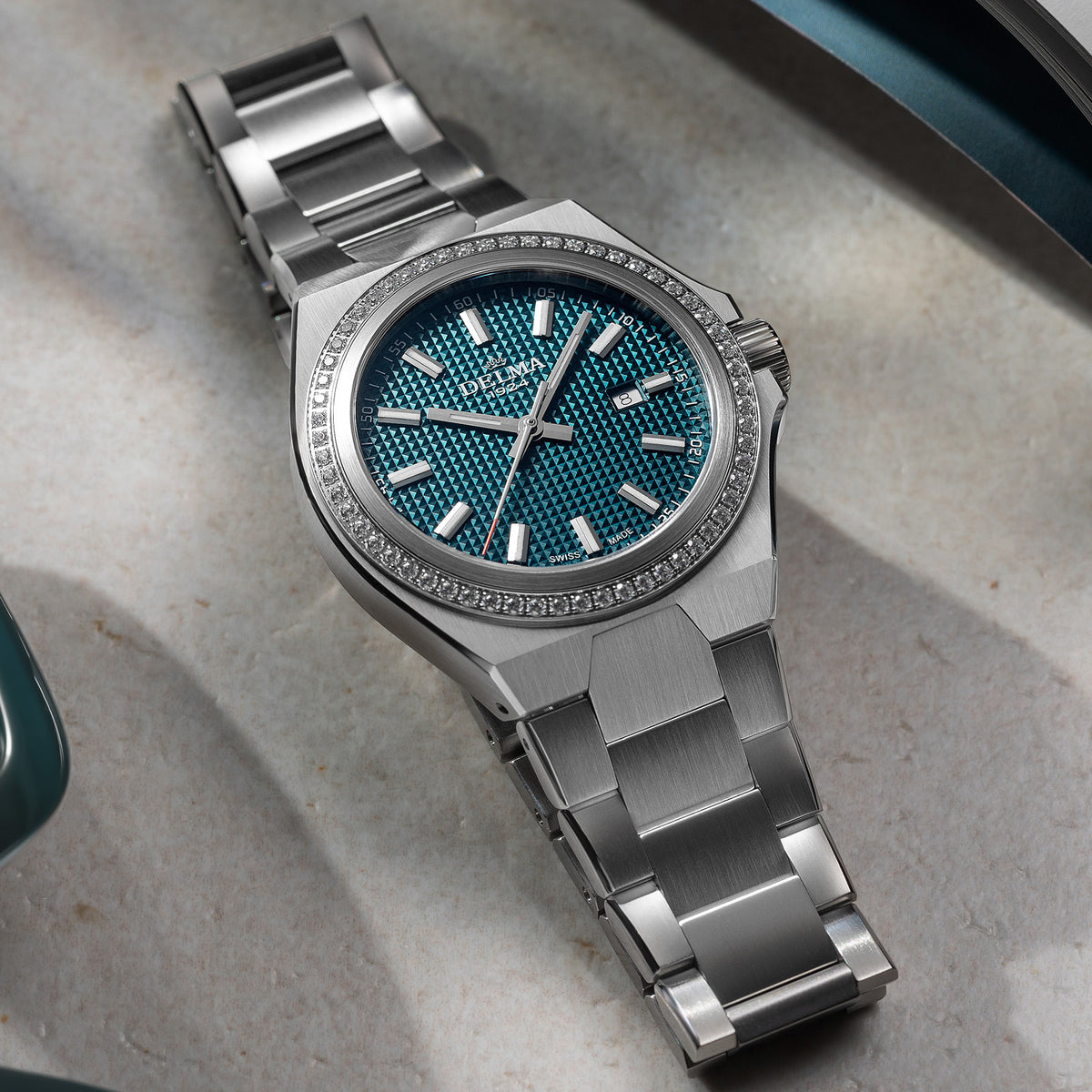 DELMA Midland 34 mm stainless steel watch with teal dial and diamond bezel in context