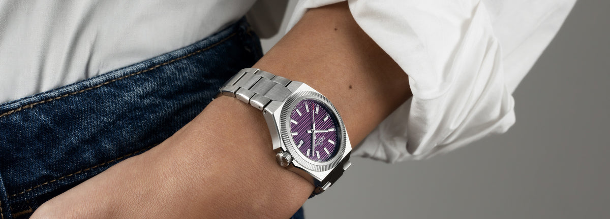 DELMA Midland 34 mm stainless steel watch with purple dial on wrist