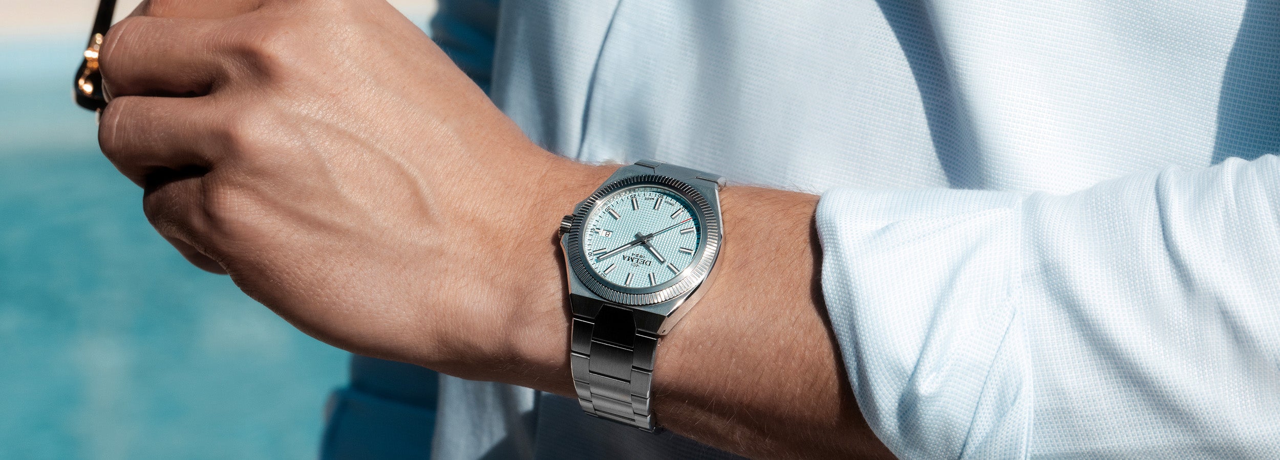 DELMA Midland 40 mm stainless steel watch with light blue dial on wrist
