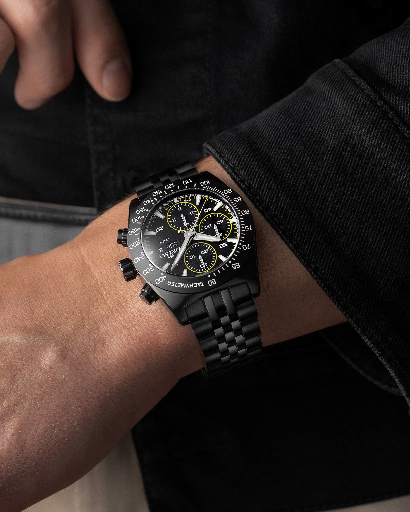 DELMA Montego Black Edition stainless steel watch with black DLC and black dial with yellow accents wrist shot