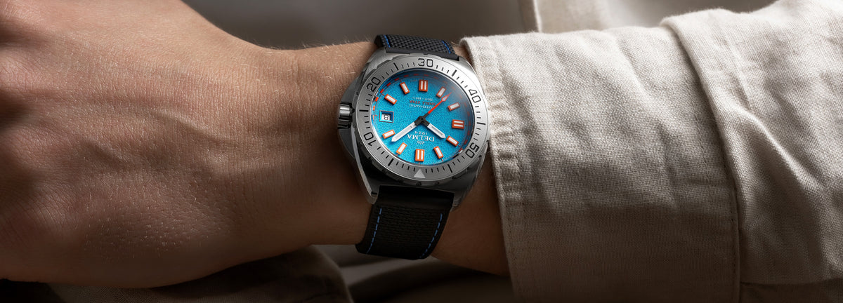 DELMA Shell Star 41 mm automatic stainless steel watch with blue dial and black rubber strap on wrist