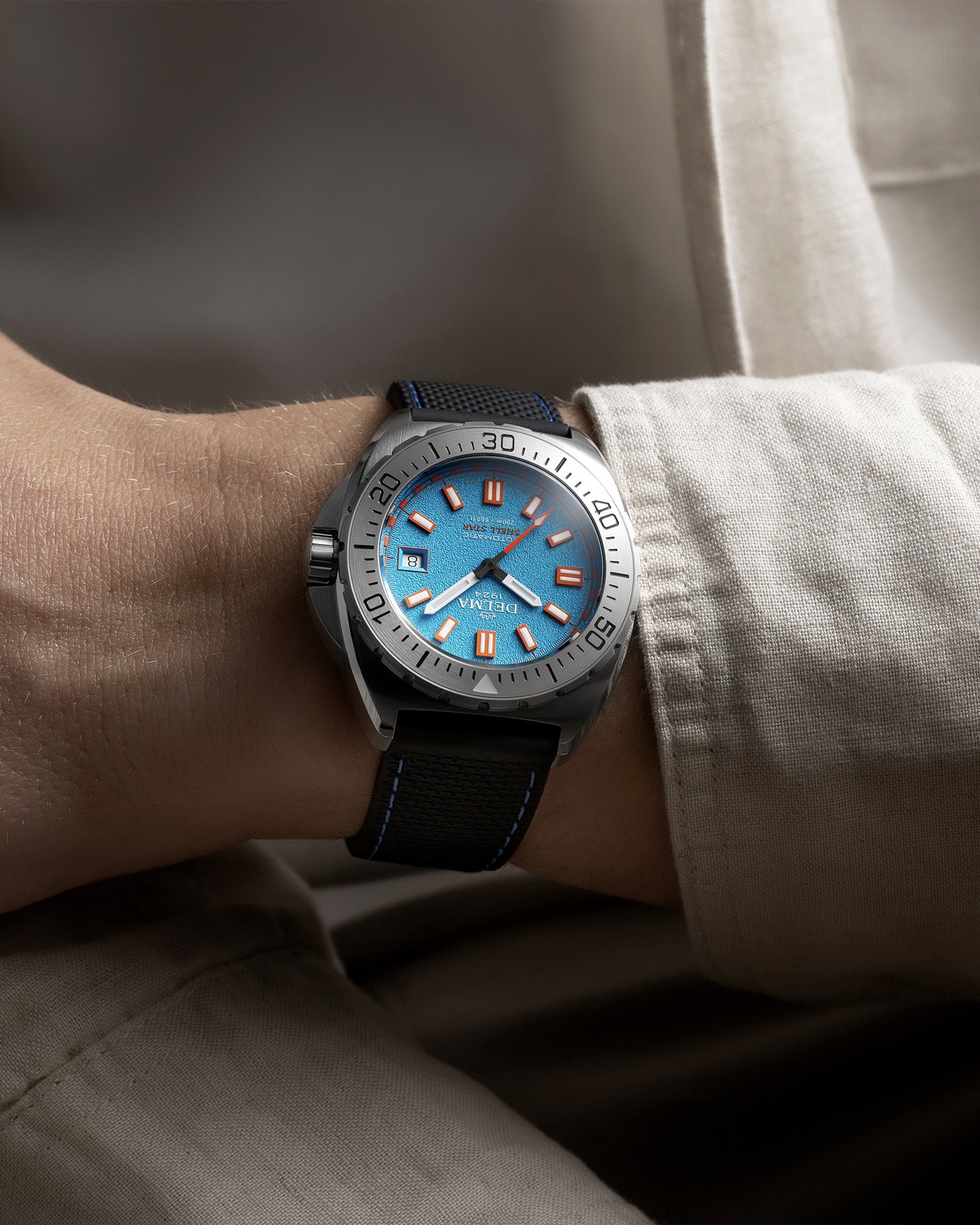DELMA Shell Star 41 mm Automatic stainless steel watch with blue dial and black rubber strap wrist shot