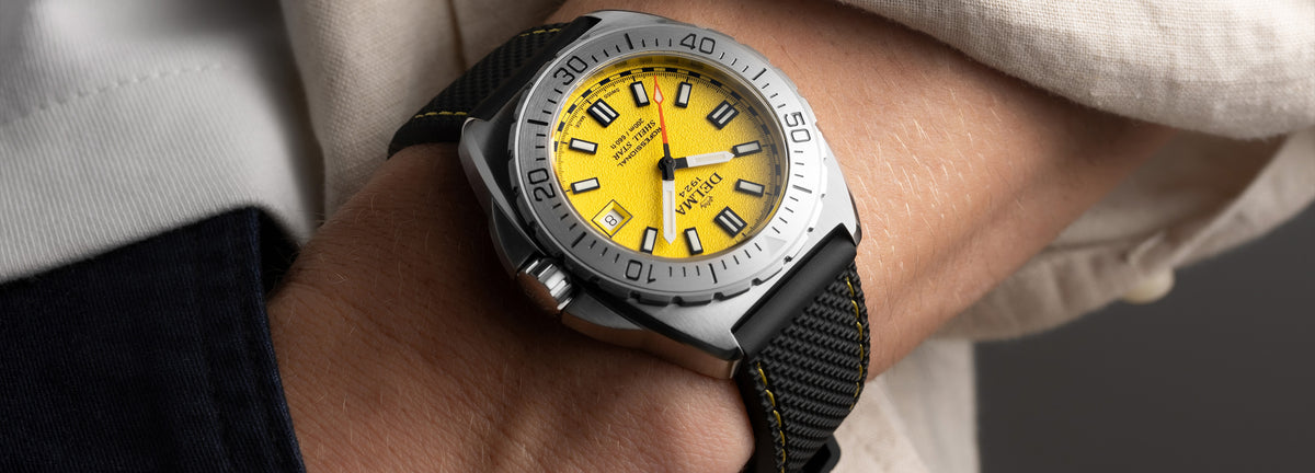 DELMA Shell Star 41 mm stainless steel watch with yellow dial and black rubber strap wrist shot