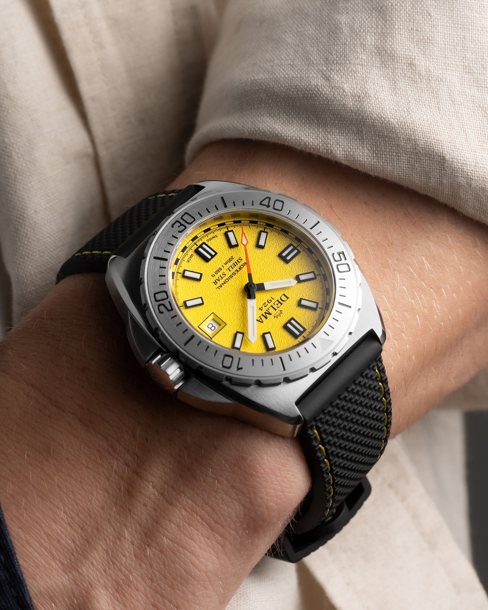 DELMA Shell Star 41 mm stainless steel watch with yellow dial and black rubber strap wrist shot