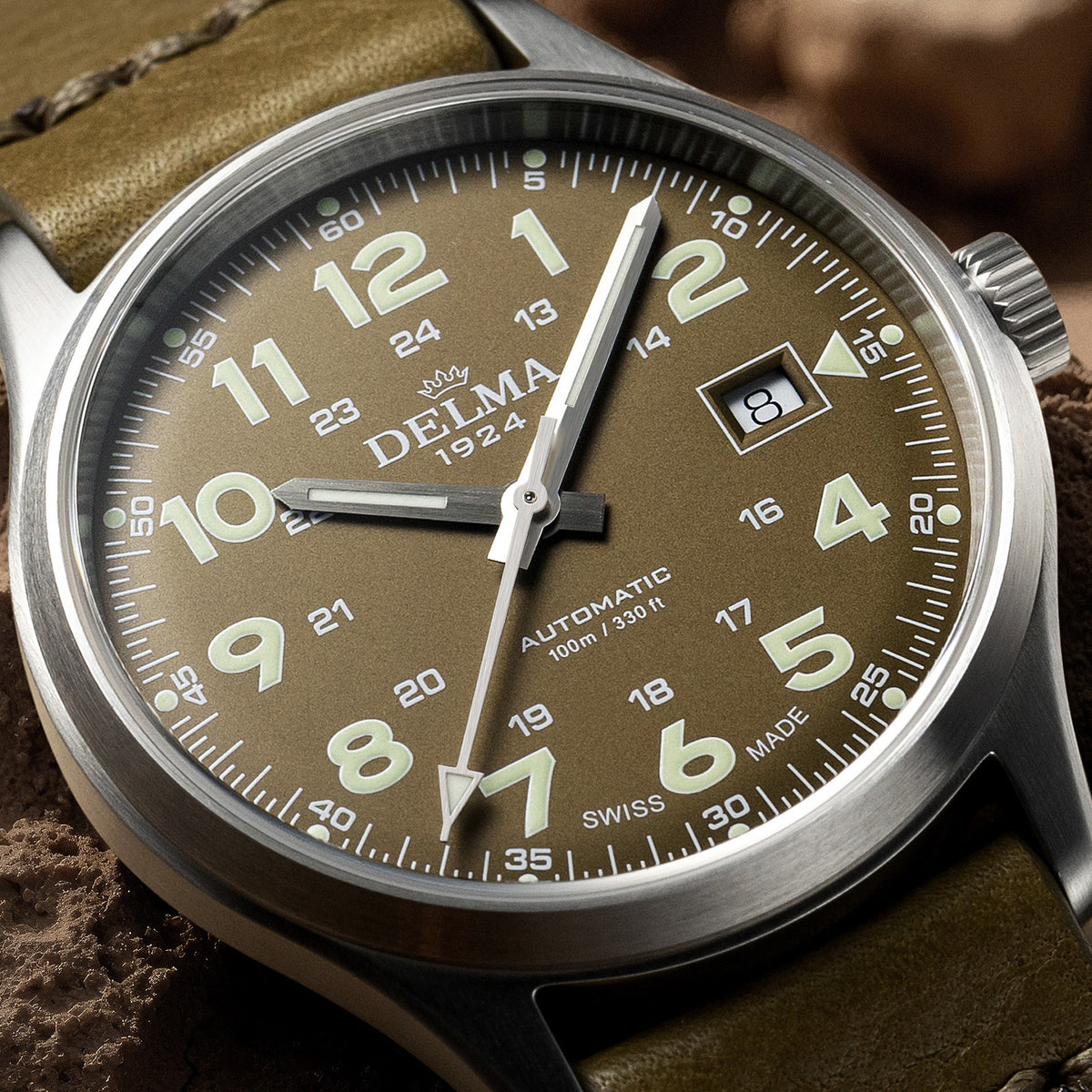 DELMA Commander 40 mm stainless steel watch with olive dial and olive leather strap close up