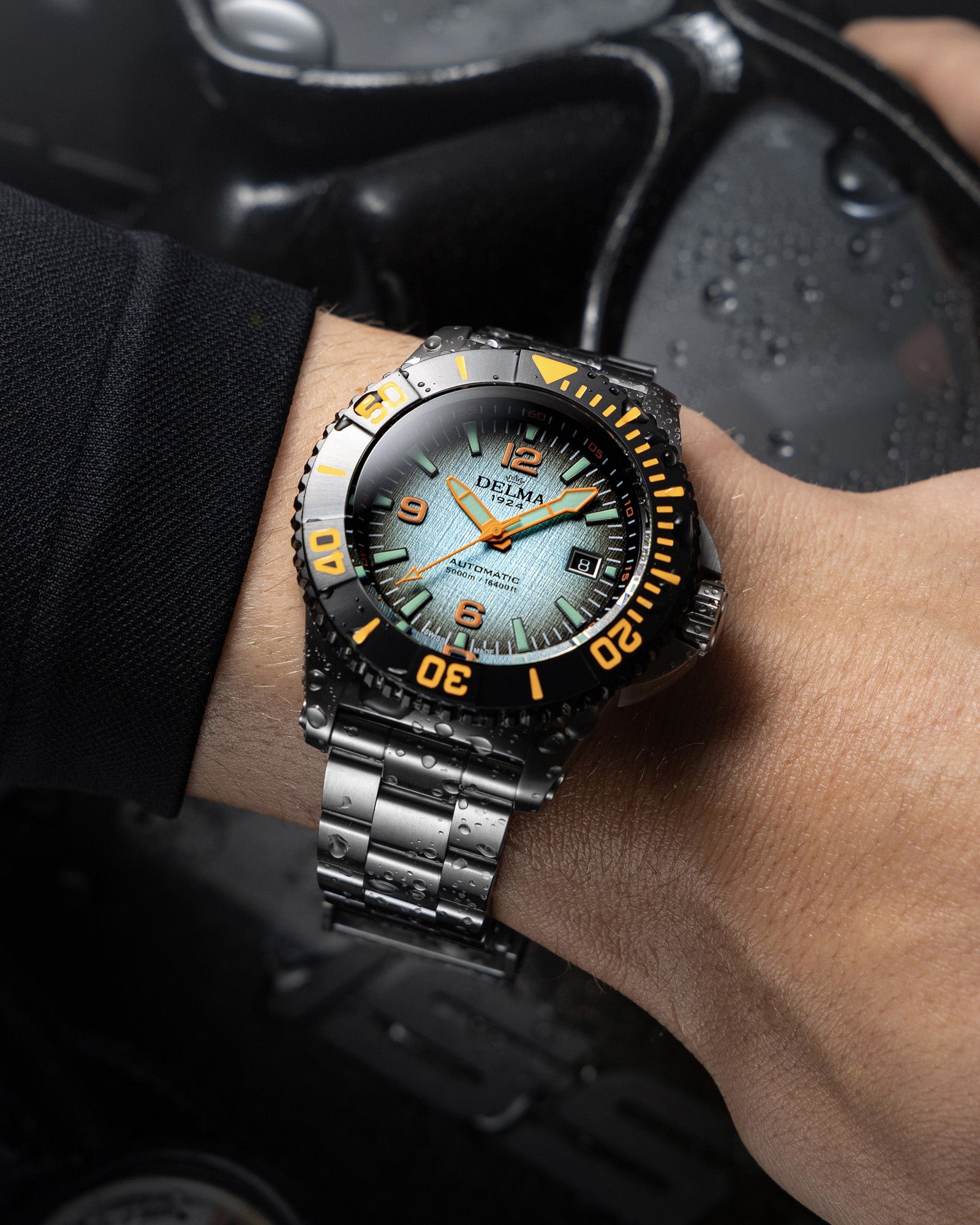 DELMA Blue Shark IV stainless steel watch with blue gradient dial and black bezel wrist shot