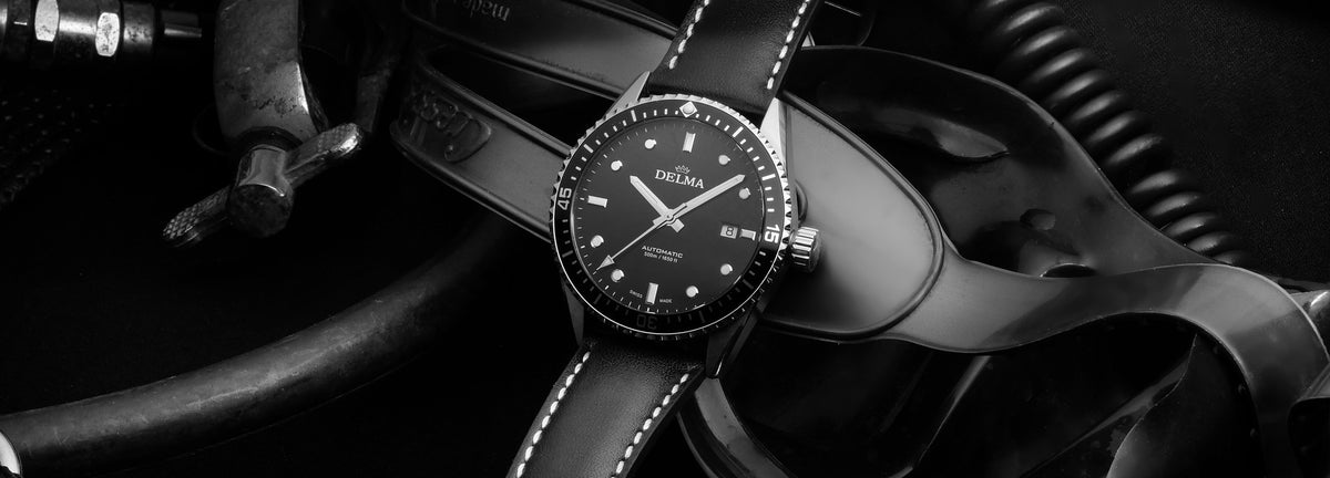 DELMA Cayman Automatic stainless steel watch with black dial, black bezel and black leather strap dive gear