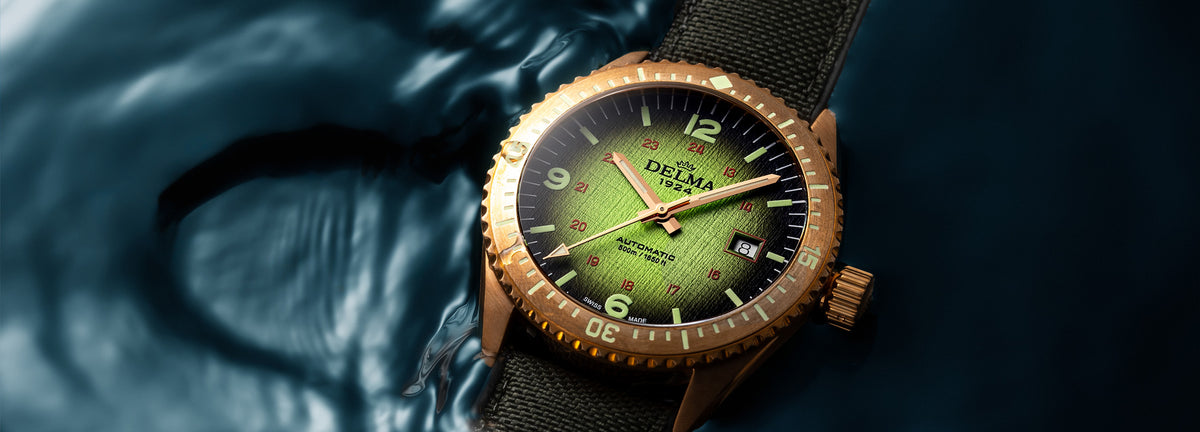 DELMA Cayman Bronze watch with green gradient dial and green Cordura strap on wrist