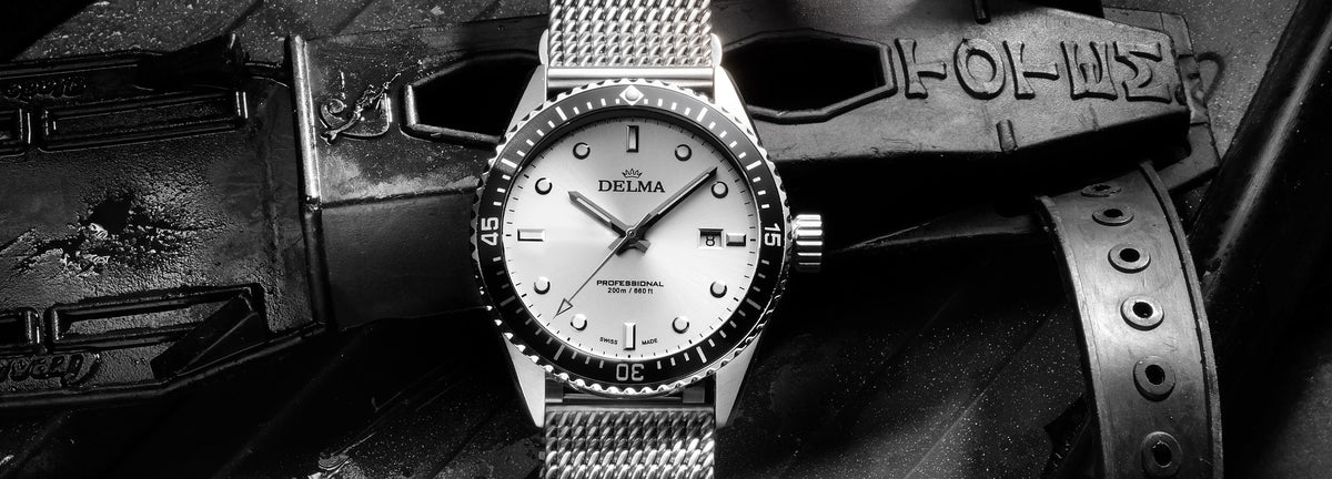 DELMA Cayman Automatic stainless steel watch with silver dial and black bezel with dive gear