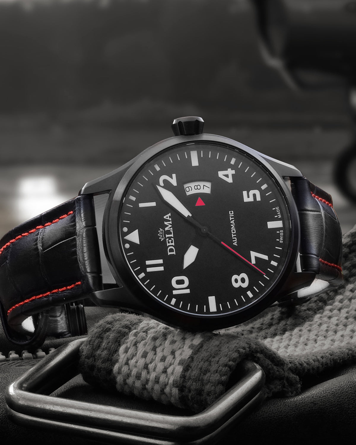 DELMA Commander stainless steel watch with black dial and black leather strap in context