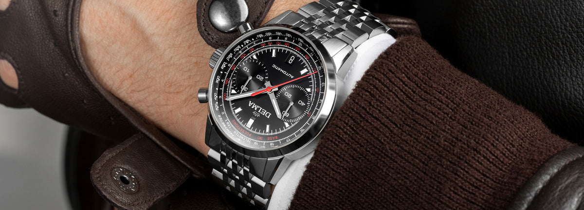 DELMA Continental Pulsometer stainless steel watch with black dial on wrist