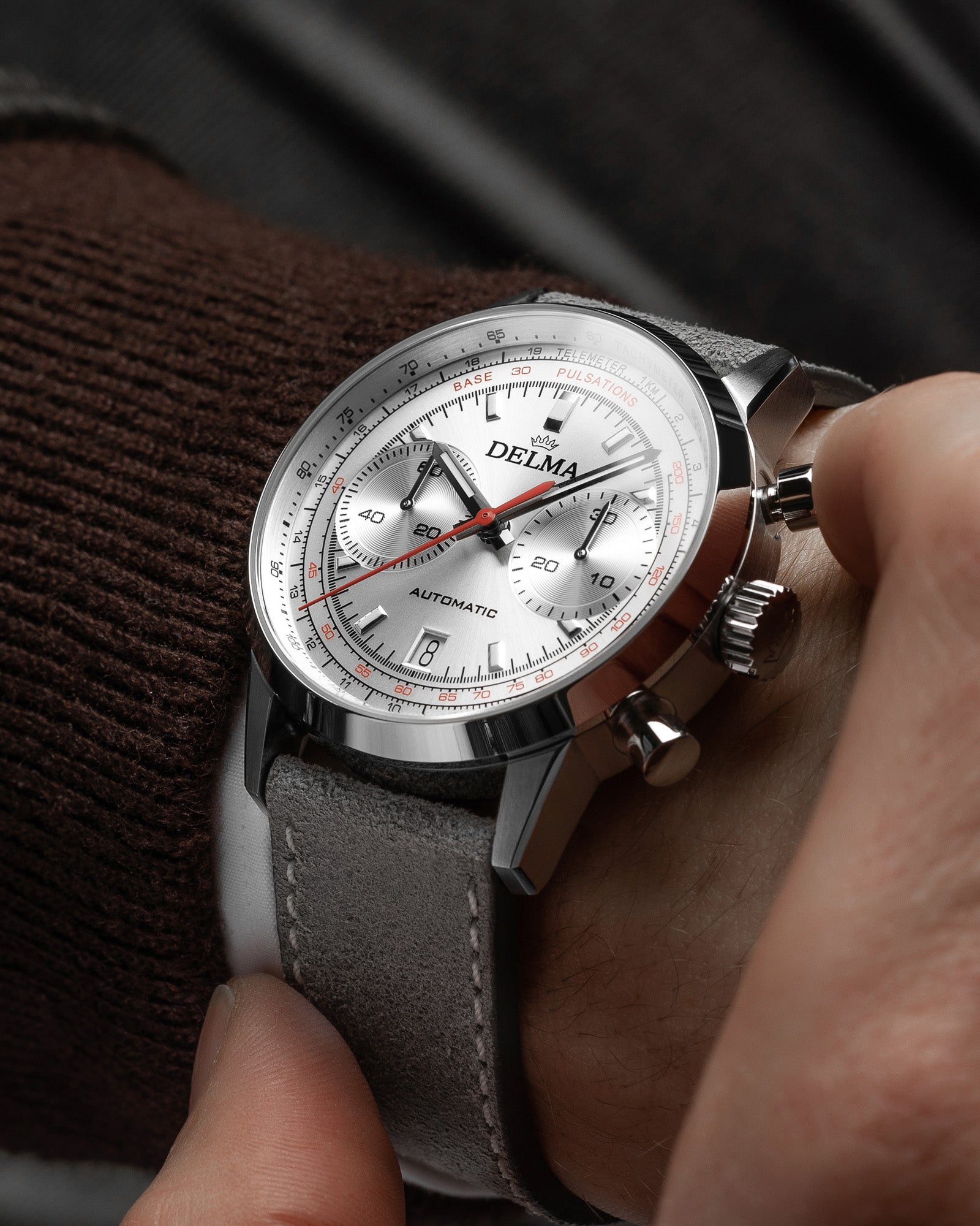 DELMA Continental Pulsometer stainless steel watch with silver dial and grey leather strap wrist shot