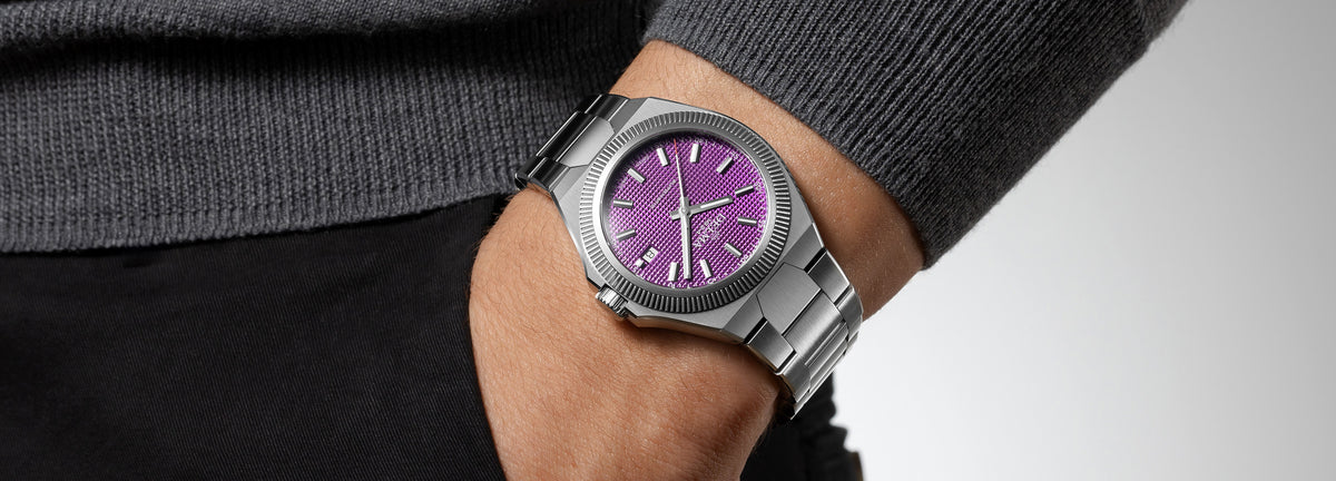 DELMA Midland Automatic 40 mm stainless steel watch with purple dial on wrist