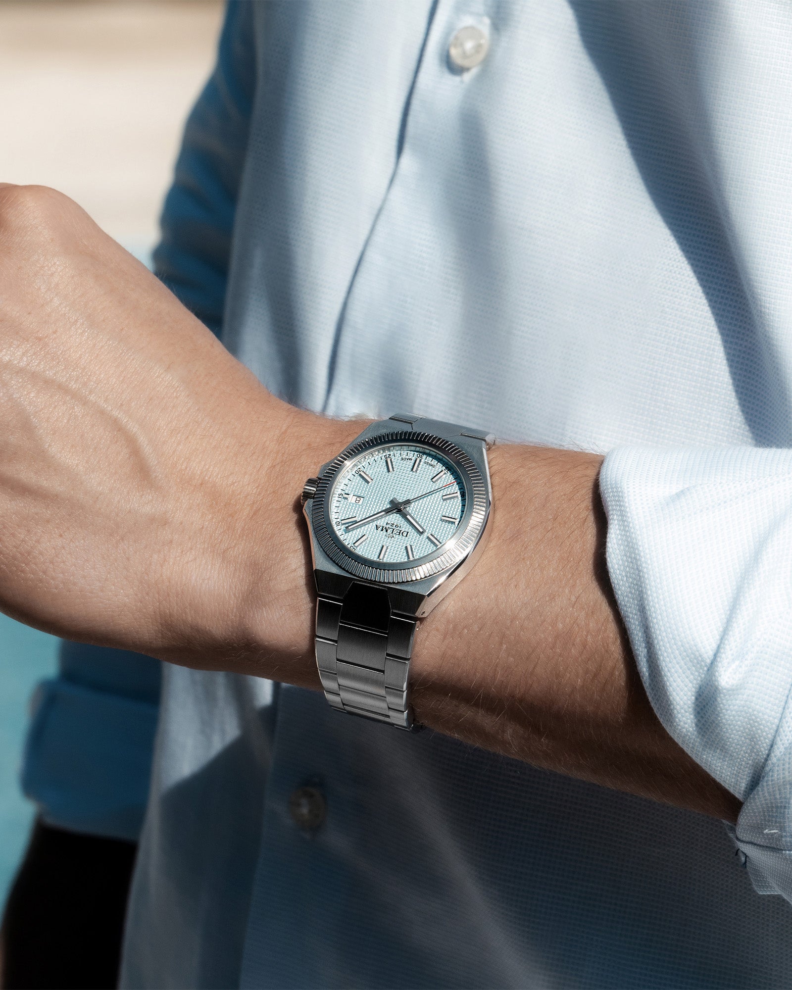 DELMA Midland 40 mm stainless steel watch with light blue dial on wrist