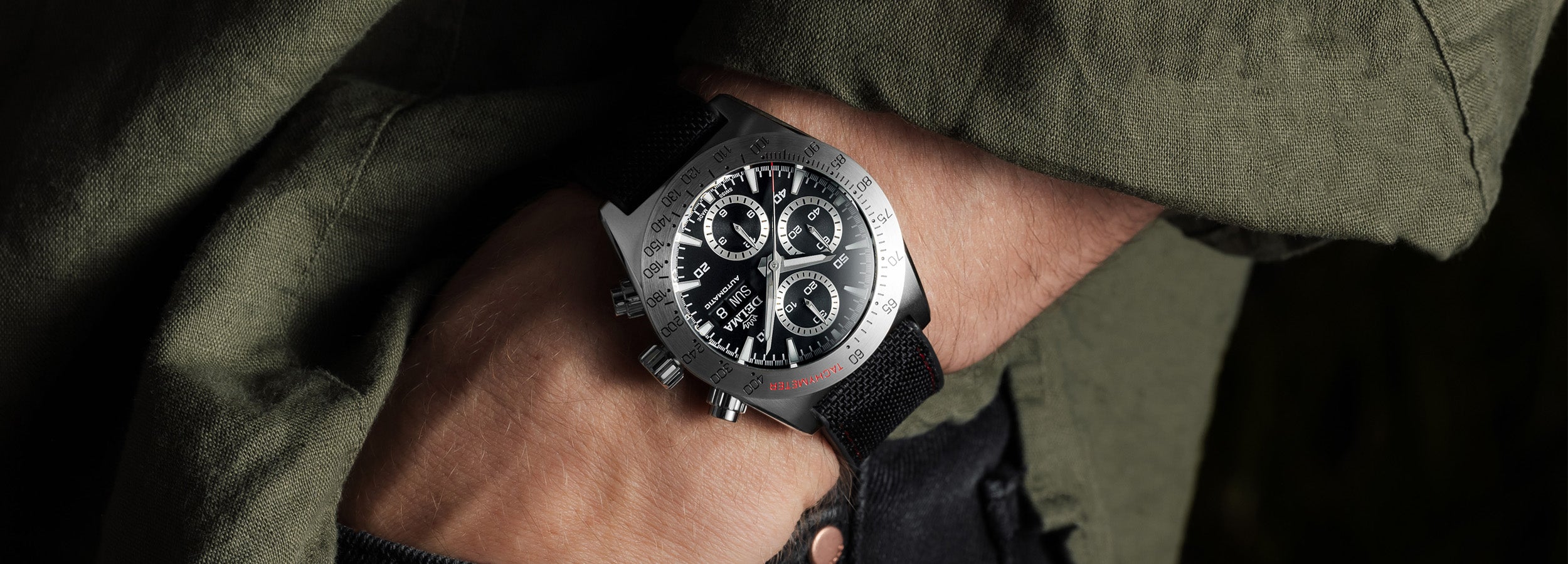 DELMA Montego stainless steel watch with black dial and black Cordura strap on wrist