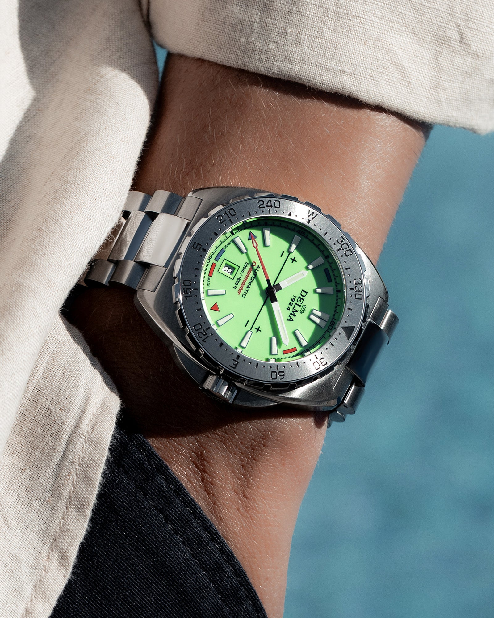 DELMA Oceanmaster Lume stainless steel watch with green luminous dial wrist shot