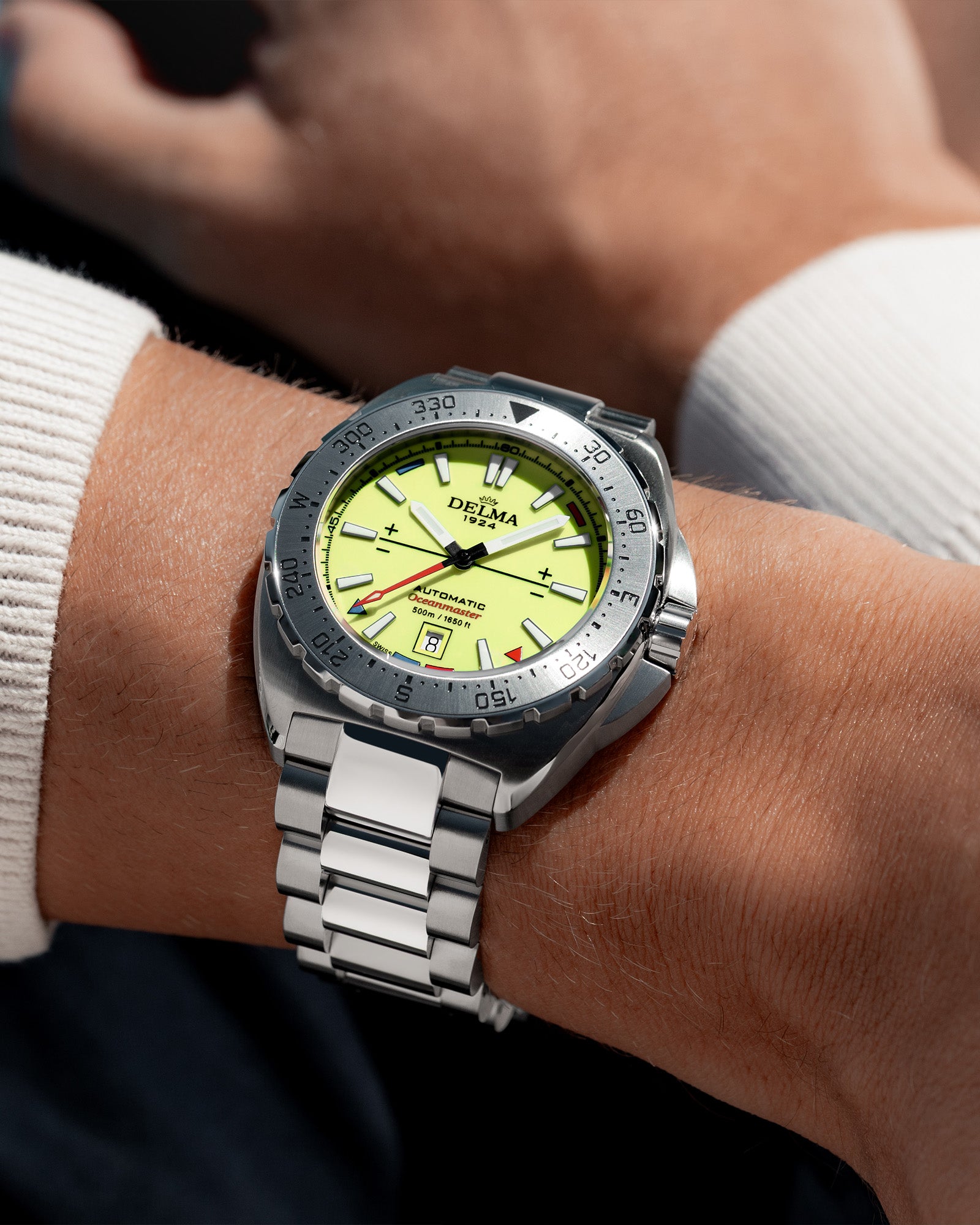 DELMA Oceanmaster Lume stainless steel watch with yellow luminous dial wrist shot