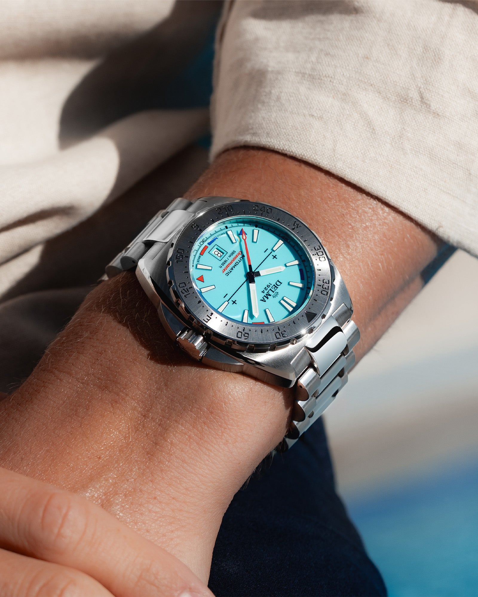 DELMA Oceanmaster Lume stainless steel watch with blue luminous dial wrist shot