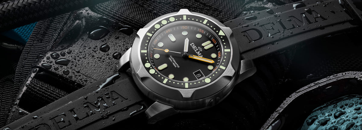 DELMA Quattro stainless steel watch with black dial and black bezel and black rubber strap