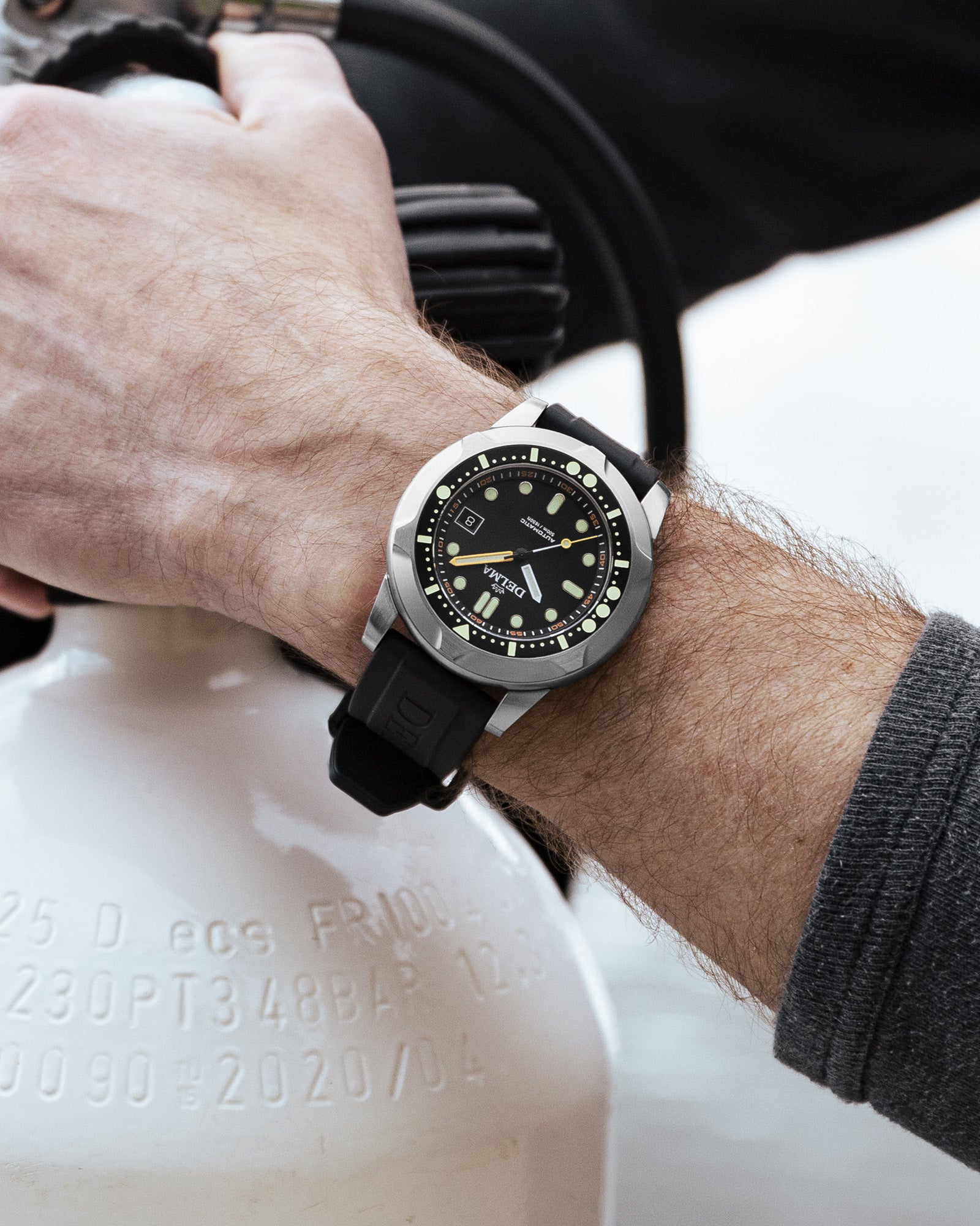 DELMA Quattro stainless steel watch with black dial and black bezel wrist shot