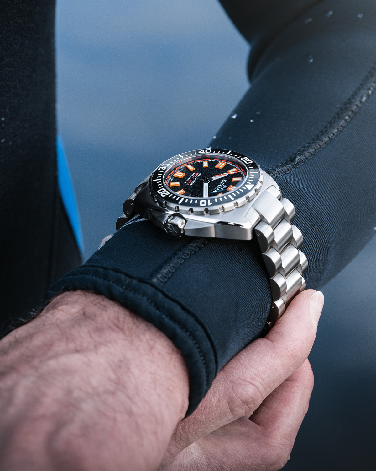 DELMA Shell Star Titanium watch with black dial and black bezel on wrist