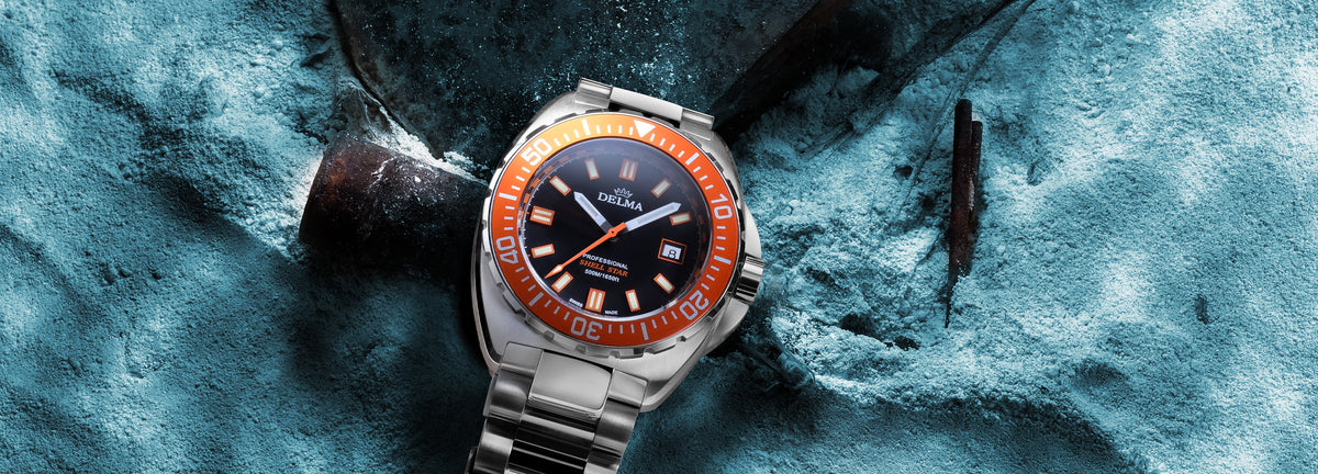 DELMA Shell Star stainless steel watch with black dial and orange bezel underwater