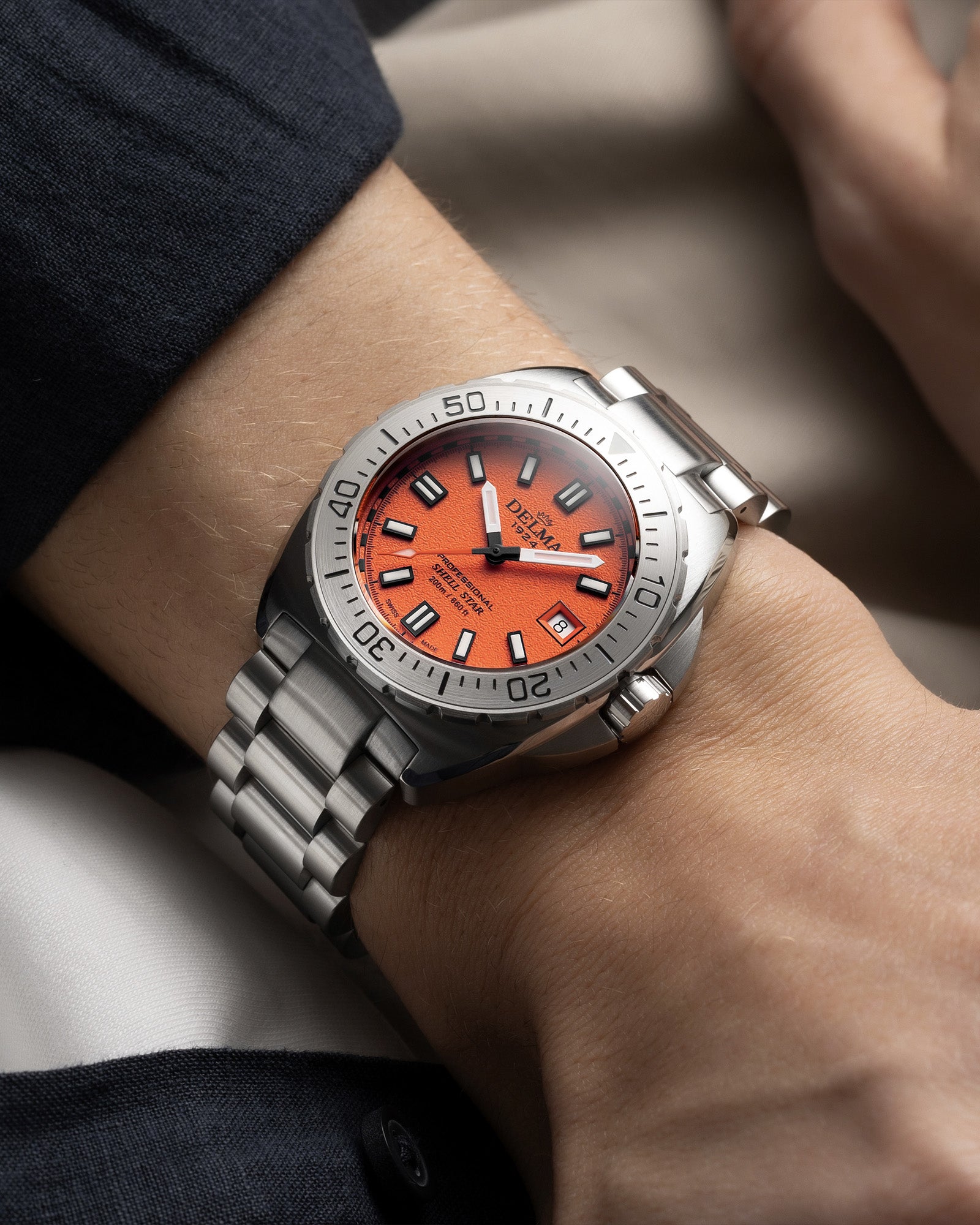 DELMA Shell Star 41 mm stainless steel watch with orange dial wrist shot